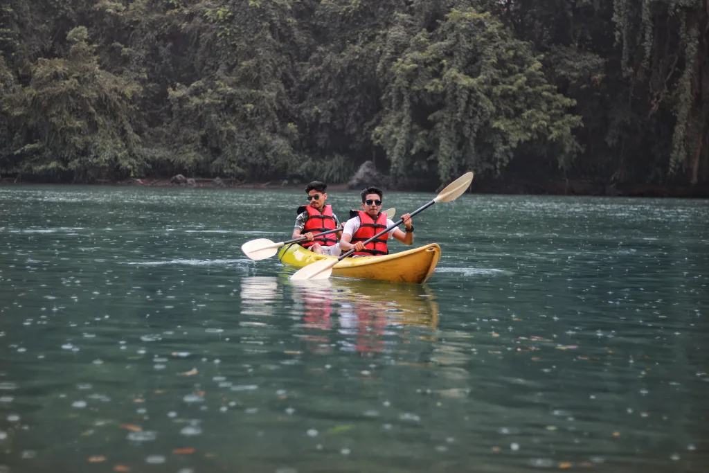 Two people paddling a canoe in a scenic lake